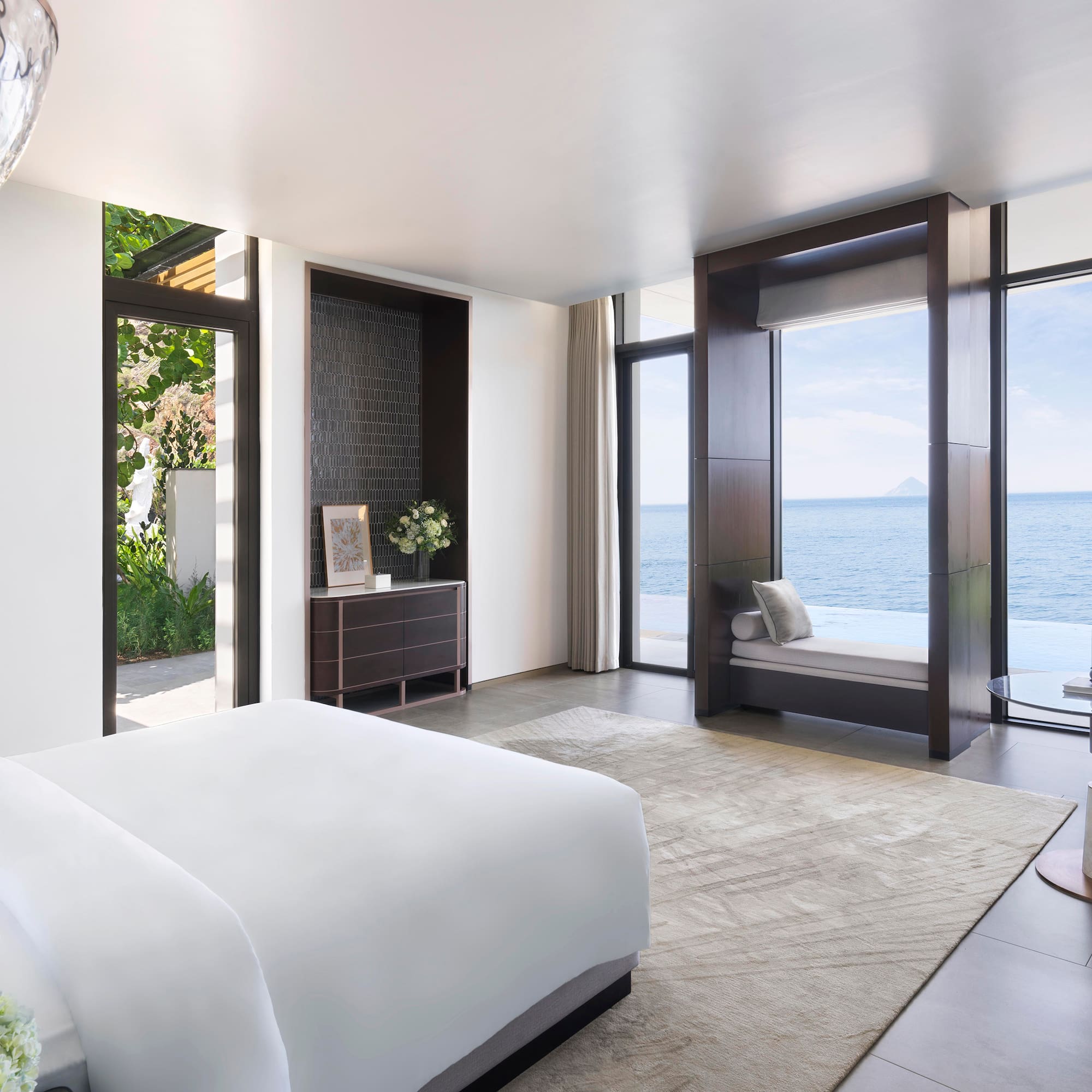 a bedroom with a view of the ocean