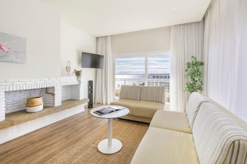 a living room with a fireplace and couches