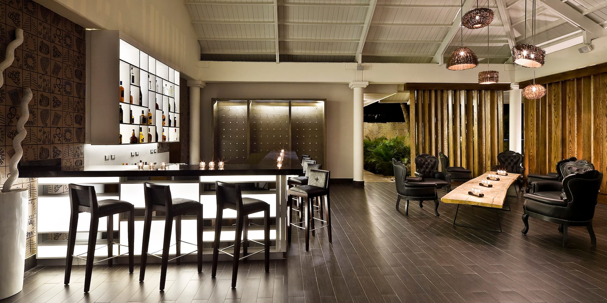 a room with a bar and chairs