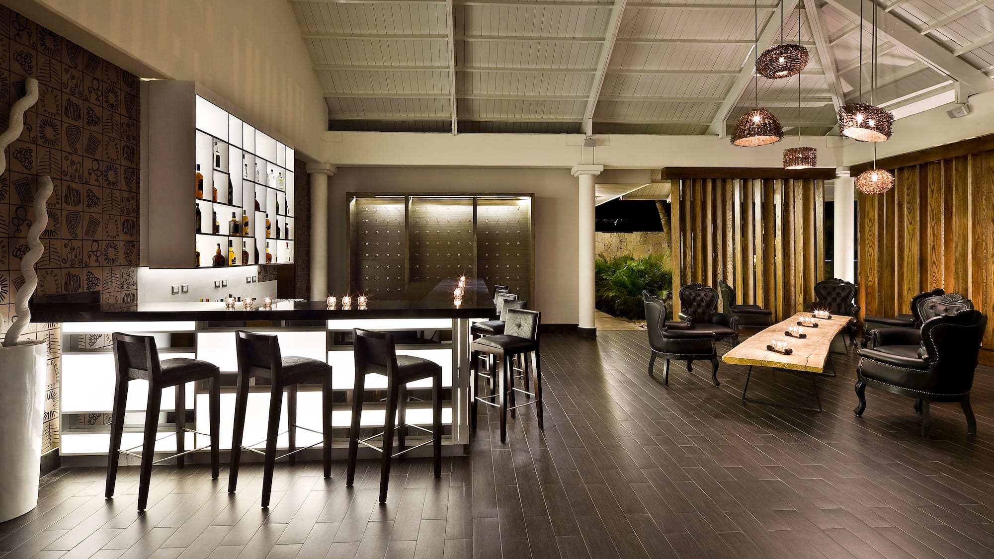 a room with a bar and chairs