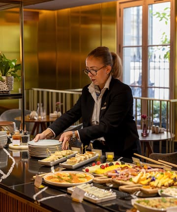 a woman standing at a buffet