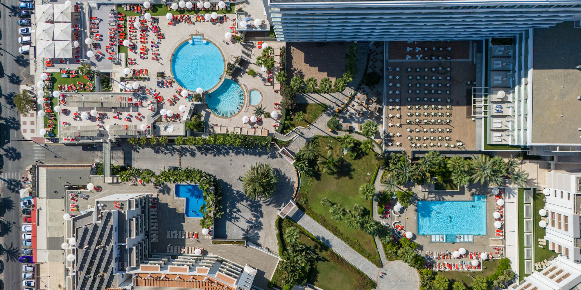 an aerial view of a resort with swimming pools and a pool