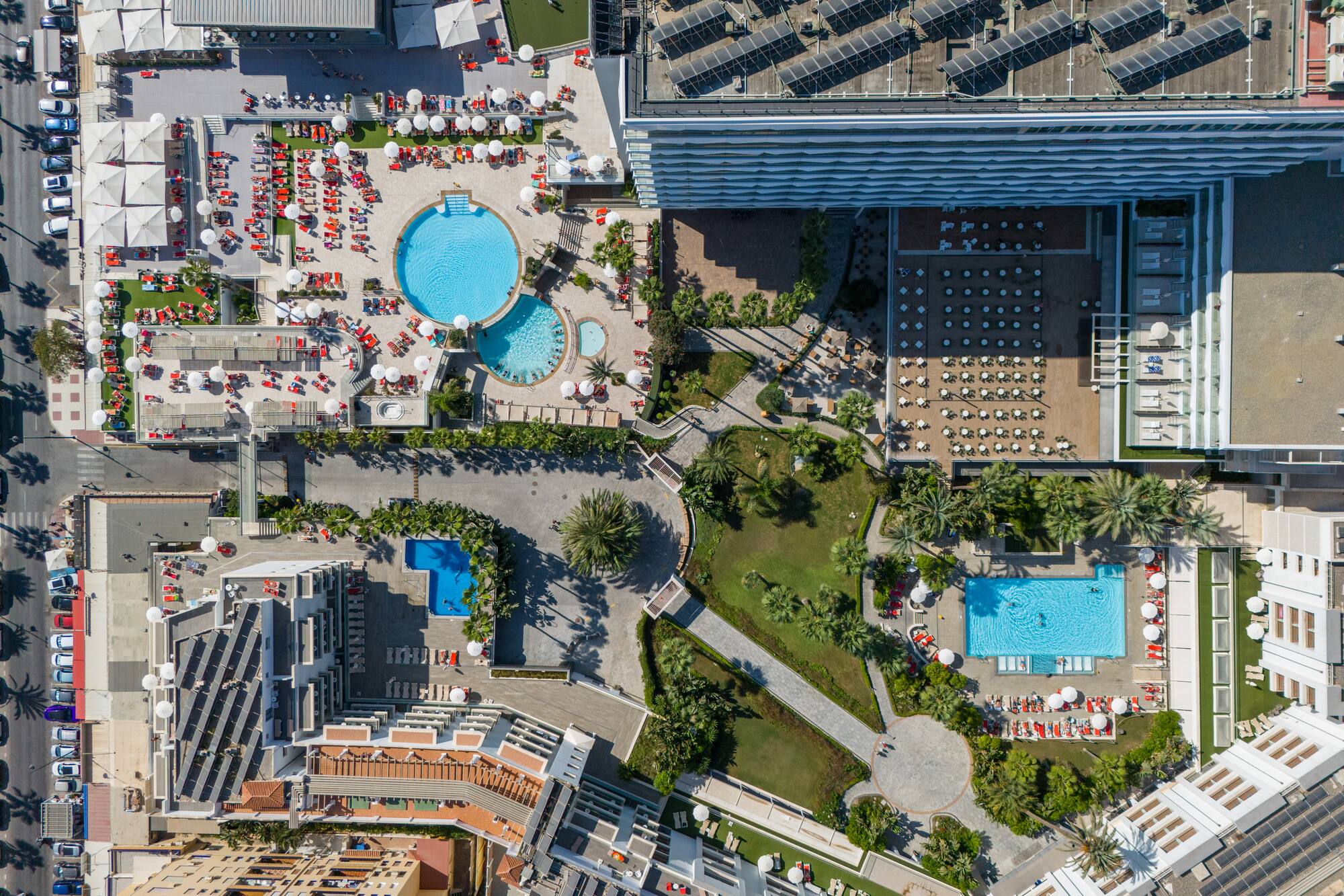 an aerial view of a resort with swimming pools and a pool