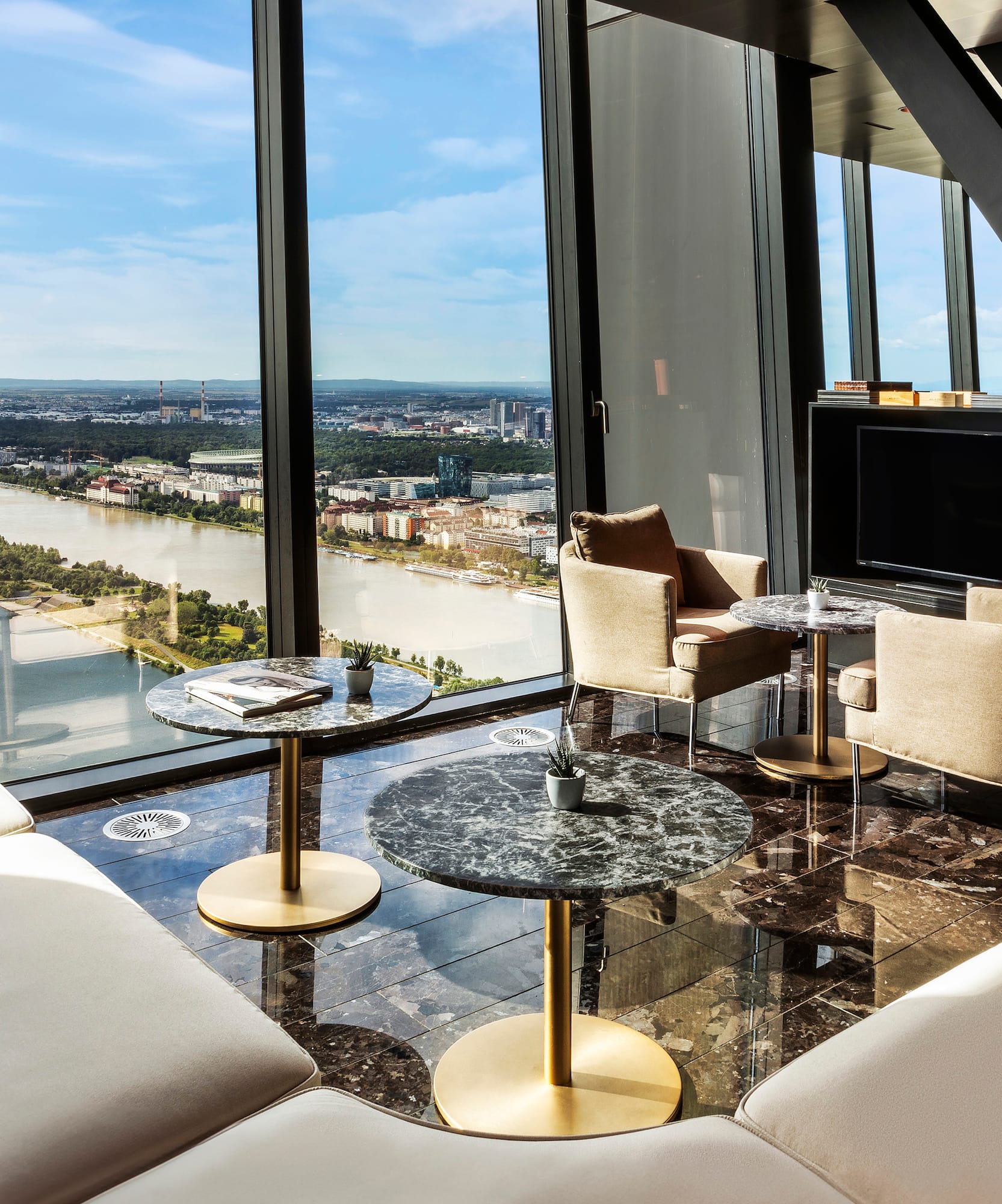 a room with a view of a river and a city.