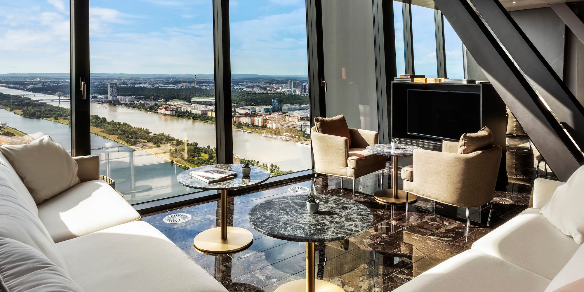 a room with a view of a river and a city