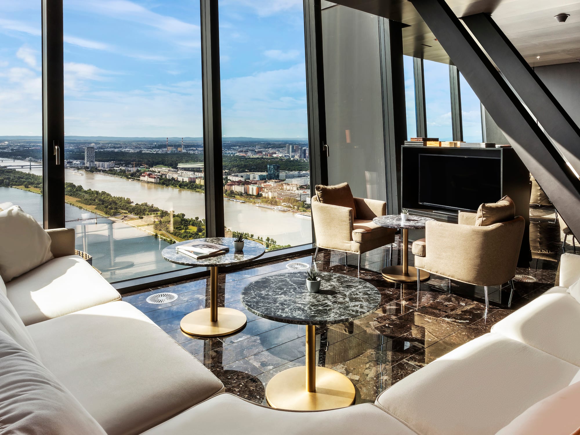 a room with a view of a river and a city.