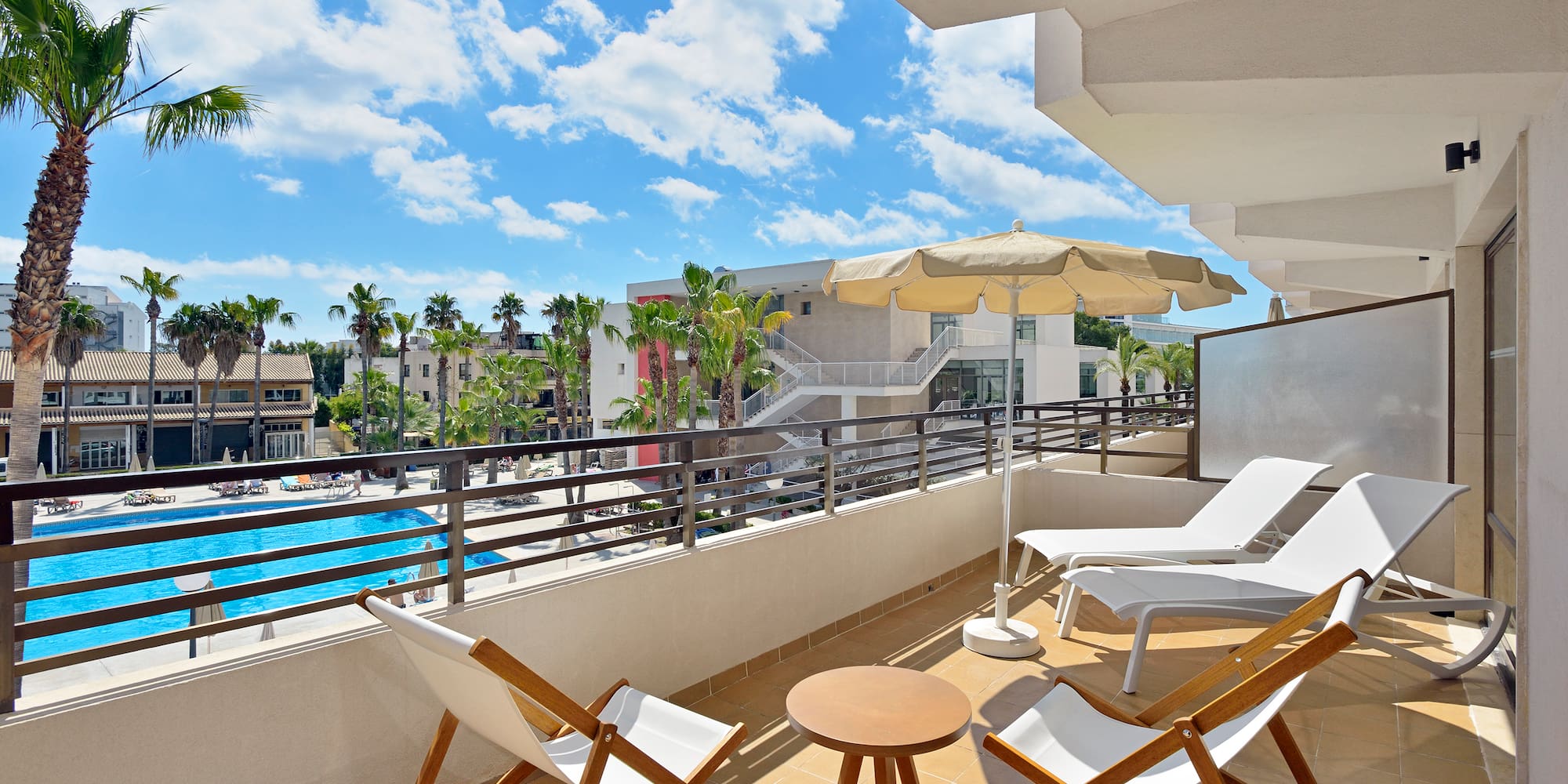 a deck with chairs and umbrellas on a balcony