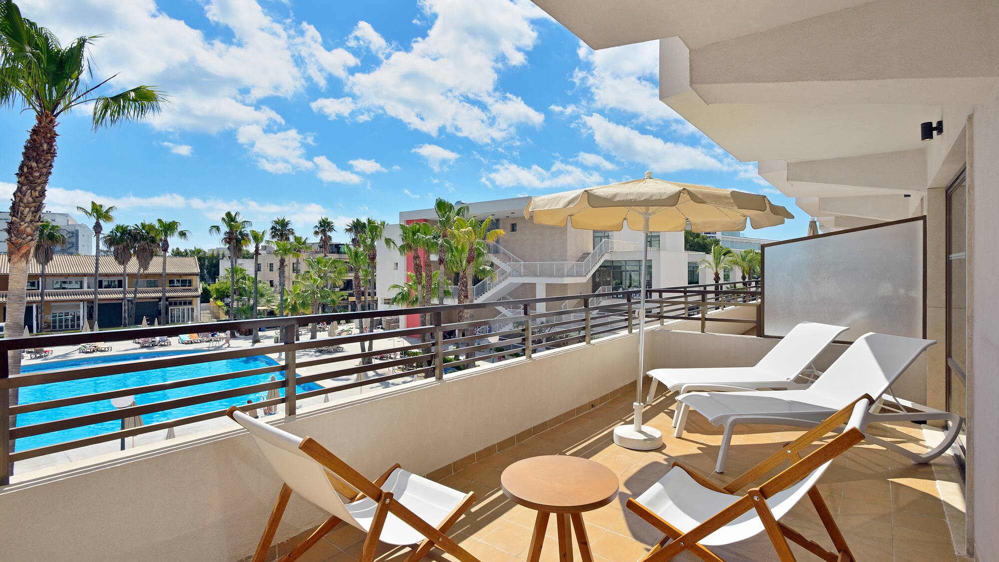 a deck with chairs and umbrellas on a balcony