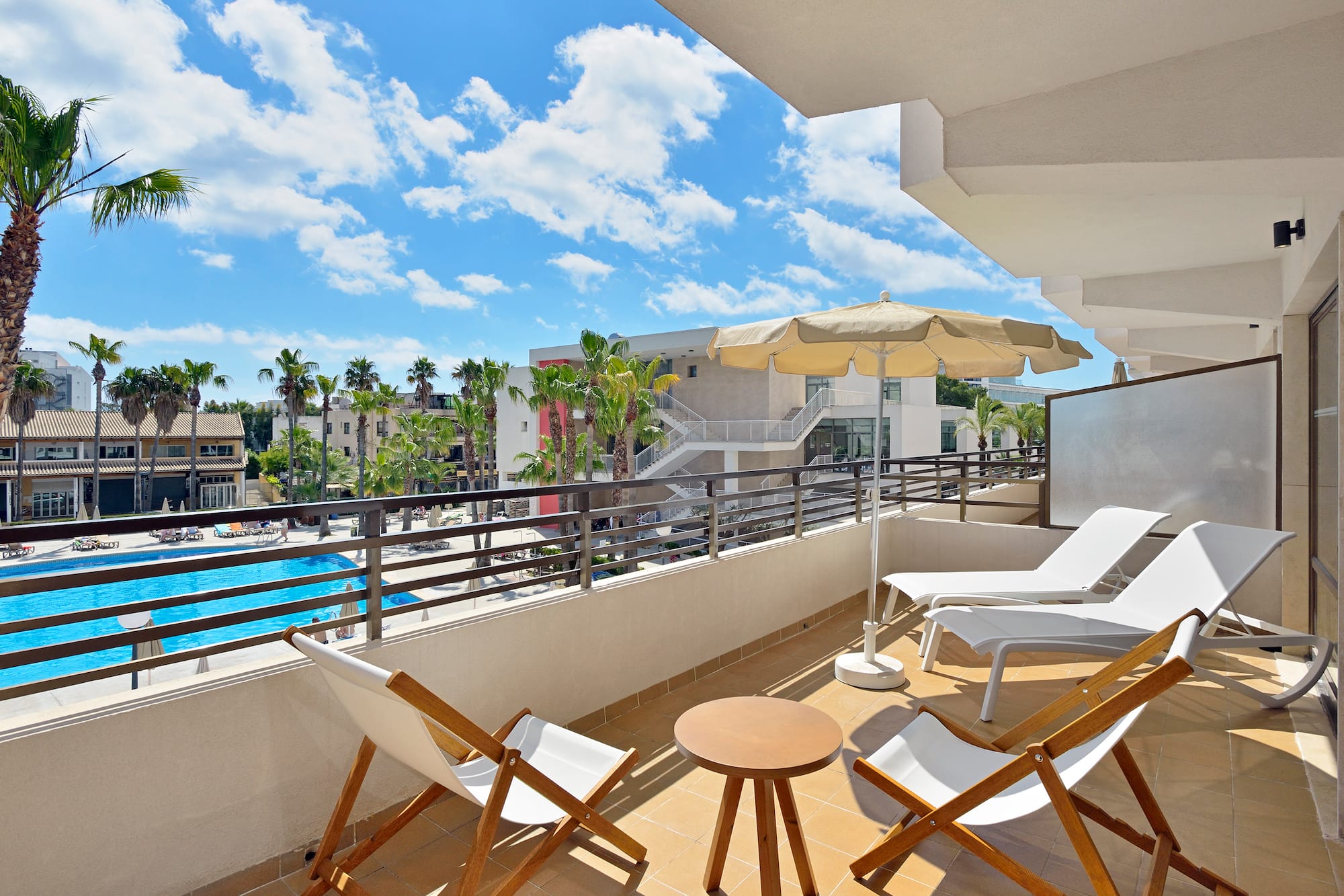 a deck with chairs and umbrellas on a balcony