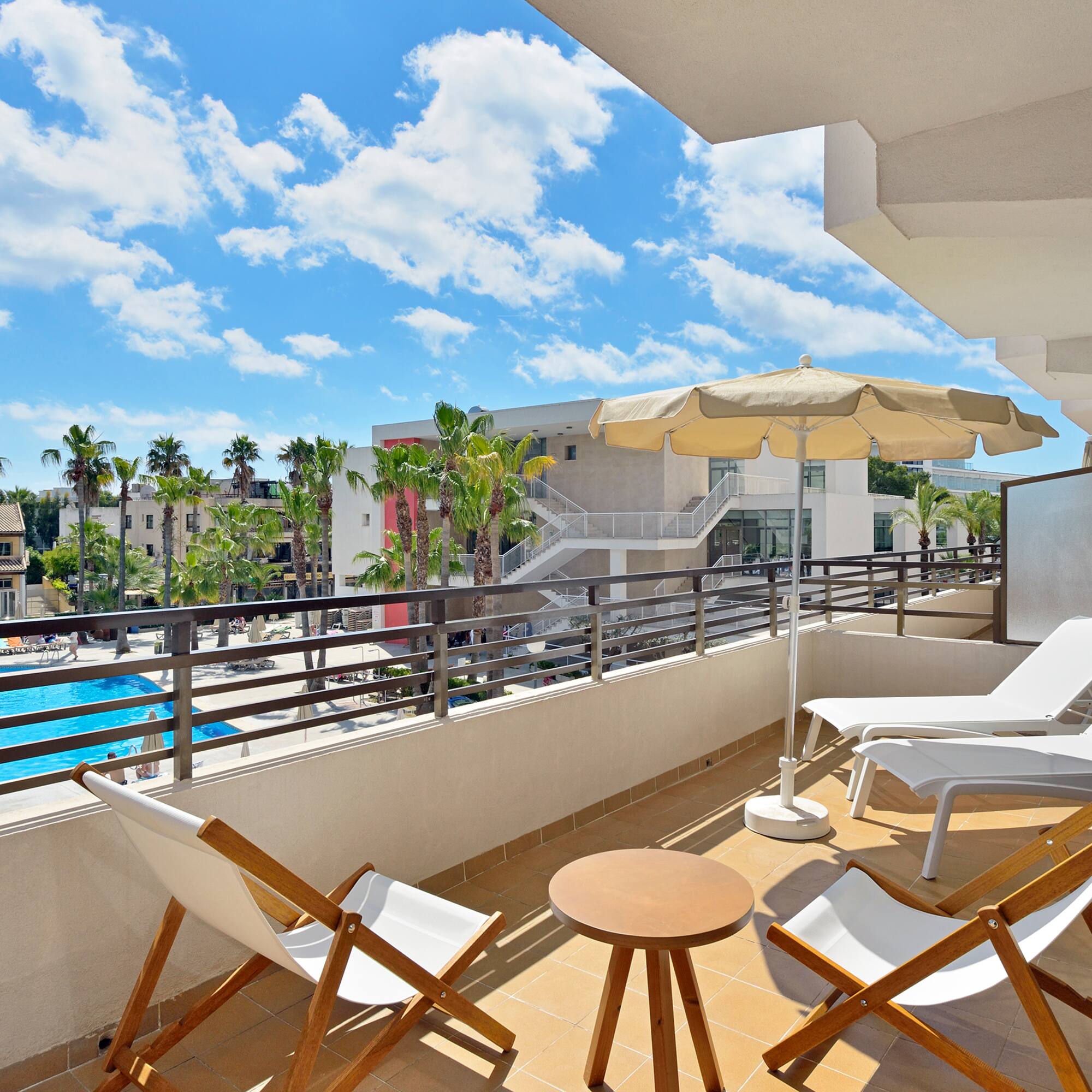 a deck with chairs and umbrellas on a balcony
