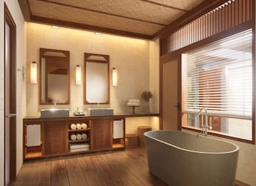 a bathroom with a tub and sinks