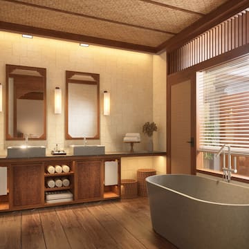 a bathroom with a tub and sinks