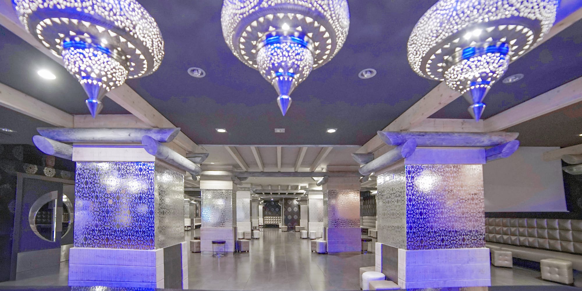a room with a large chandelier and a tiled floor
