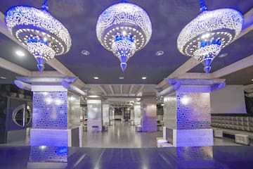 a room with a large chandelier and a tiled floor
