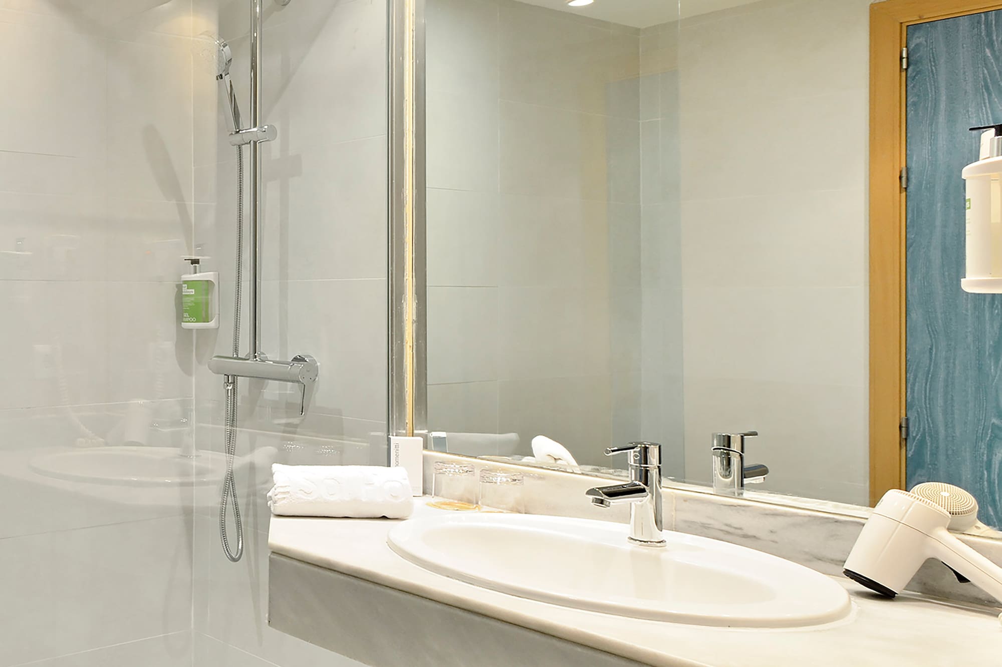 a bathroom with a shower and sink