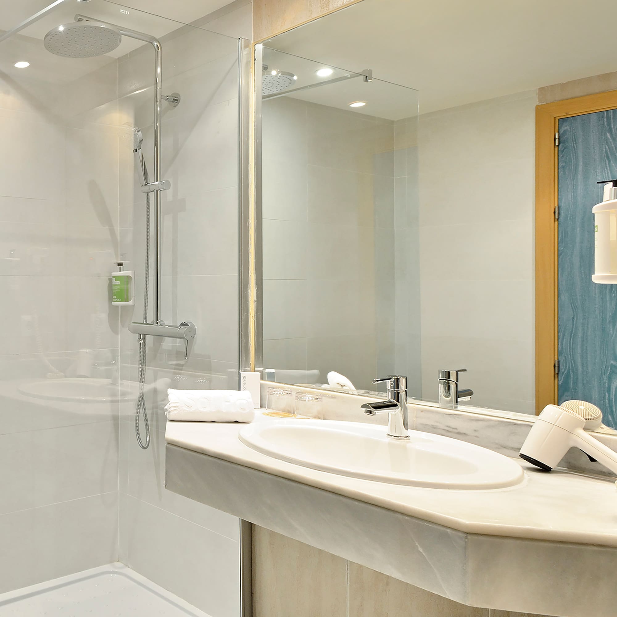 a bathroom with a shower and sink