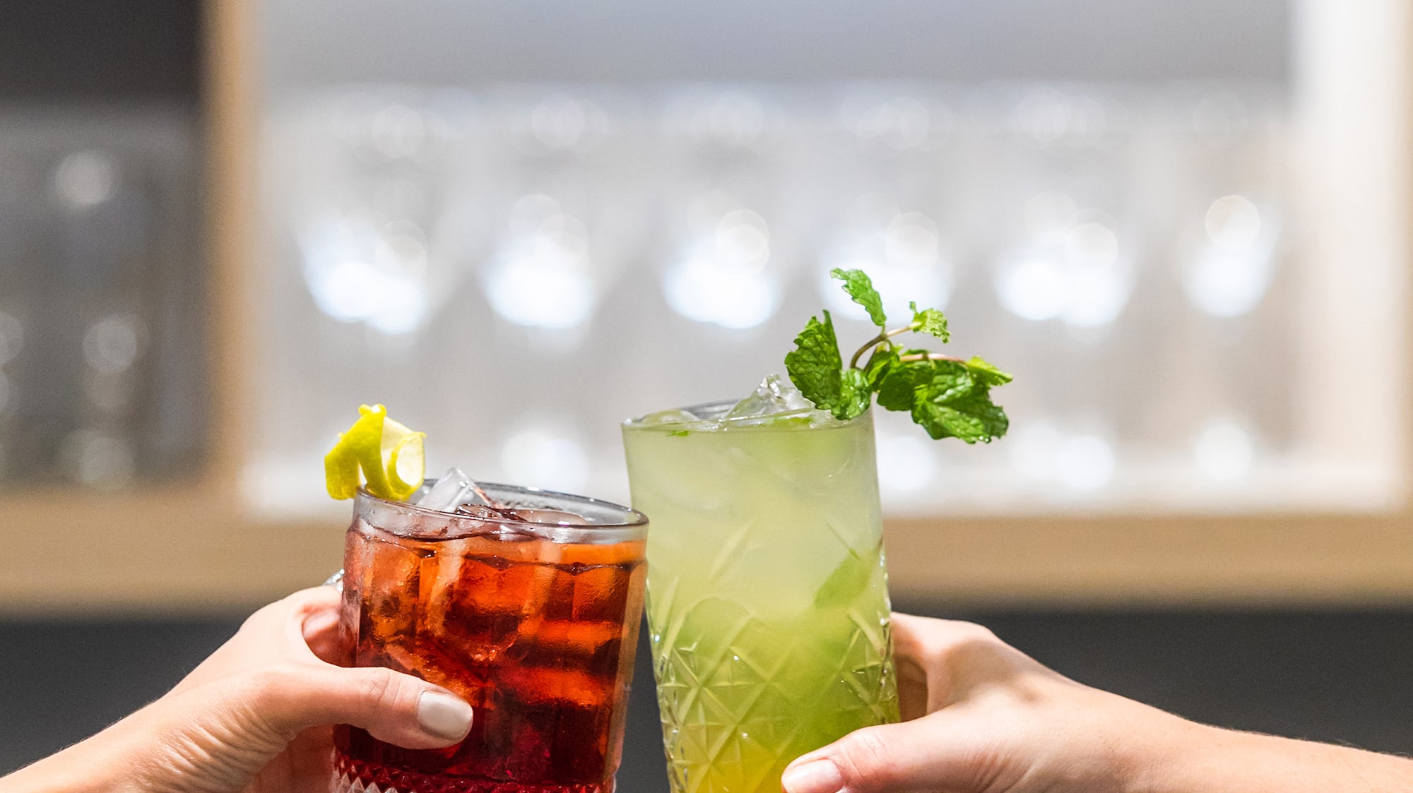 a pair of hands holding drinks