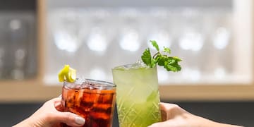 a pair of hands holding drinks