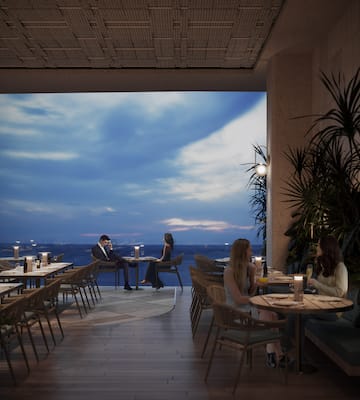 a group of people sitting at tables in a restaurant