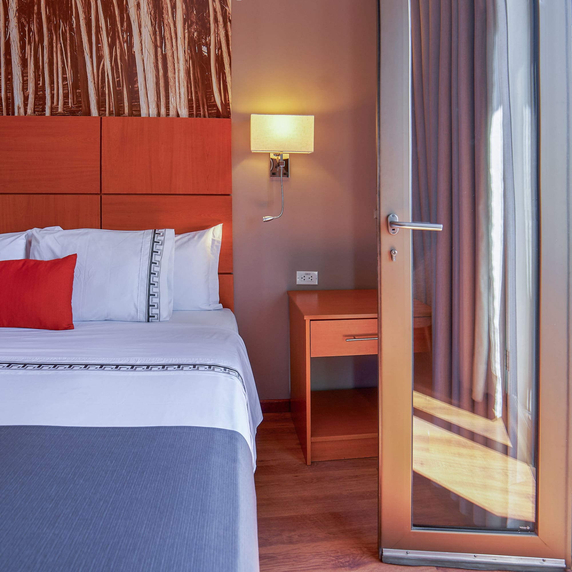 a bed with a glass door
