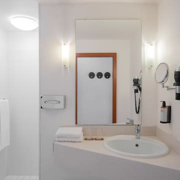 a bathroom with a mirror and a sink