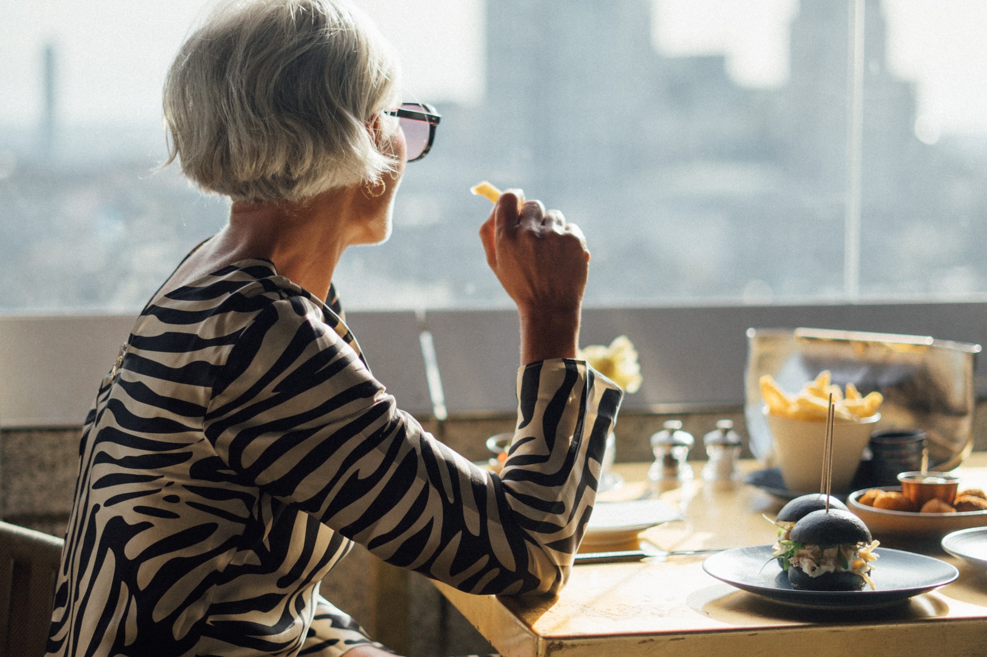 a woman eating at a table