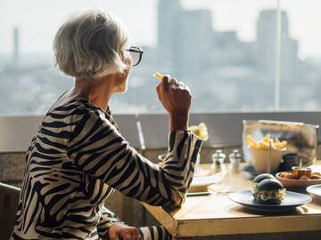 a woman eating at a table