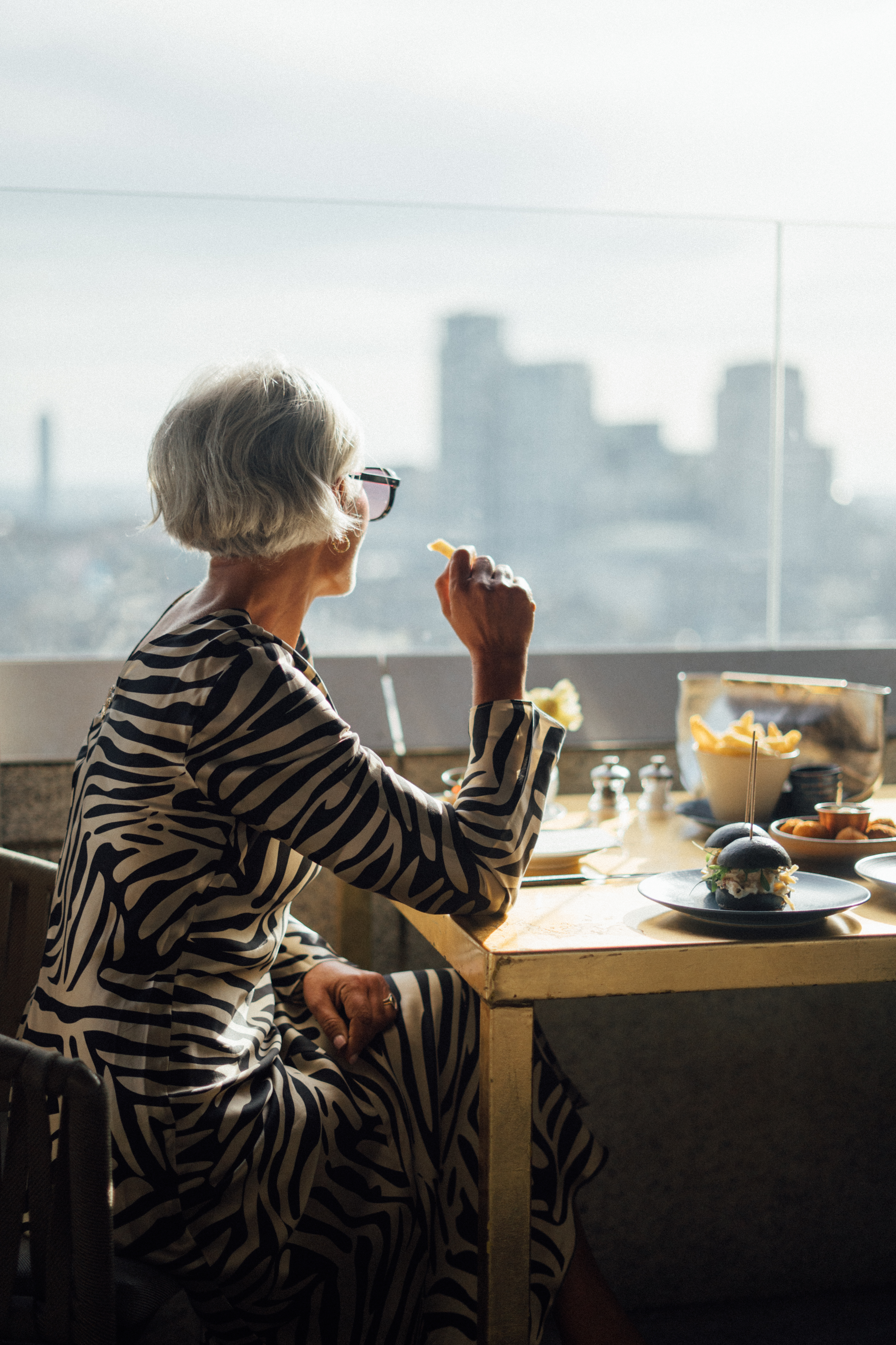 a woman eating at a table