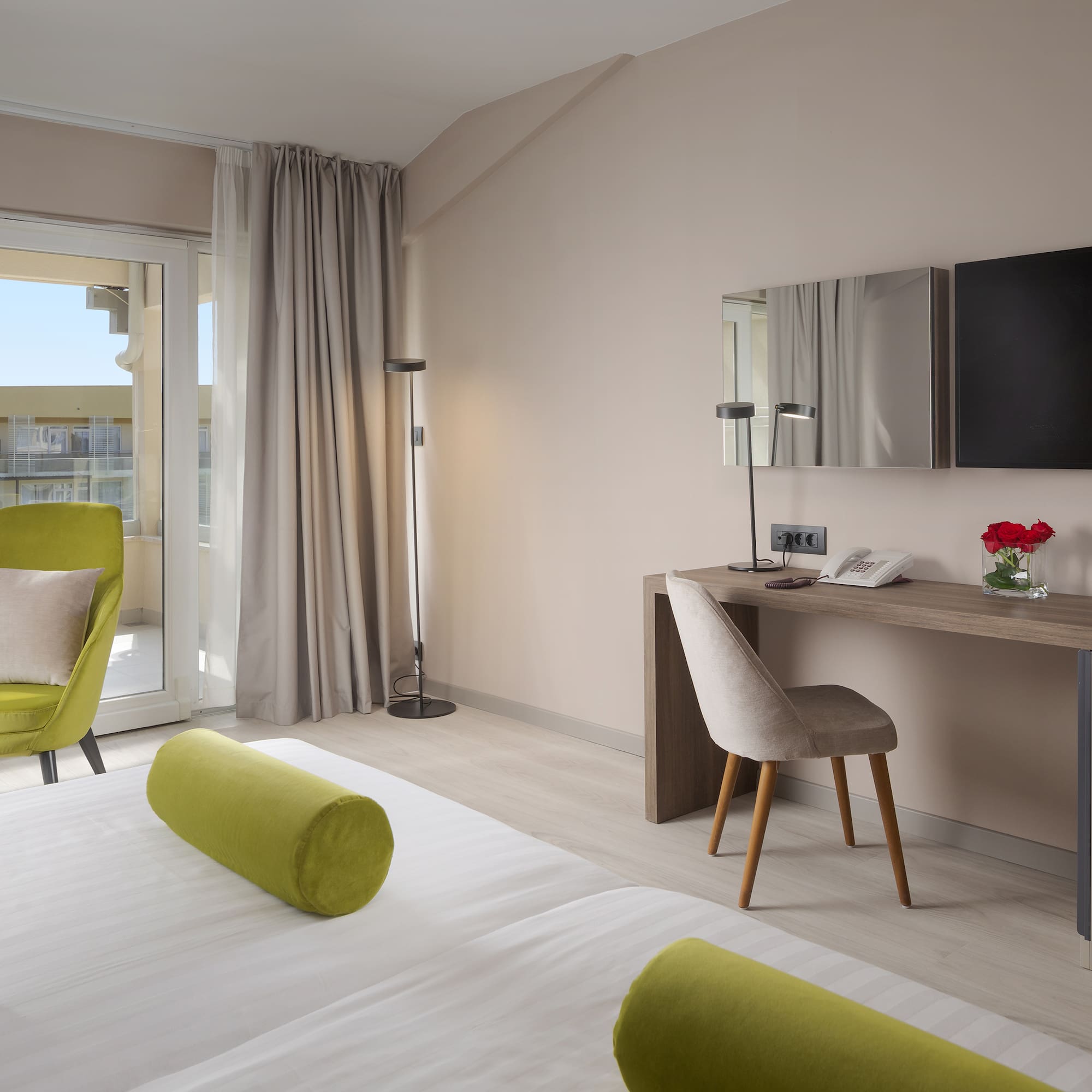 a room with a bed and a desk and a television