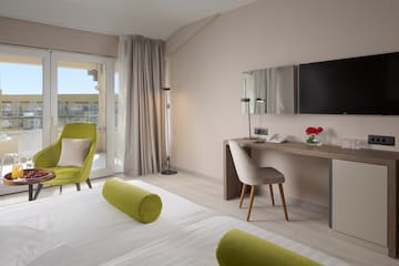 a room with a bed and a desk and chair