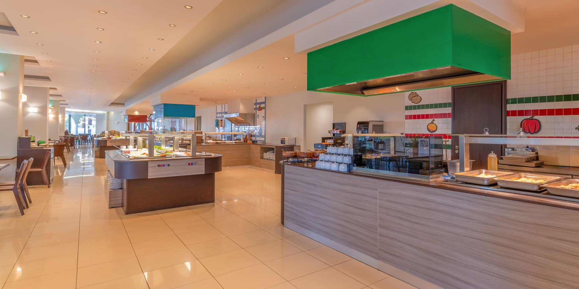 Spacious hotel buffet restaurant with various food serving stations.