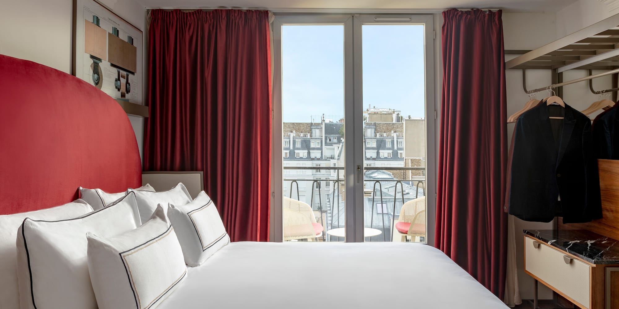 a bed with red curtains and a swinger with a window