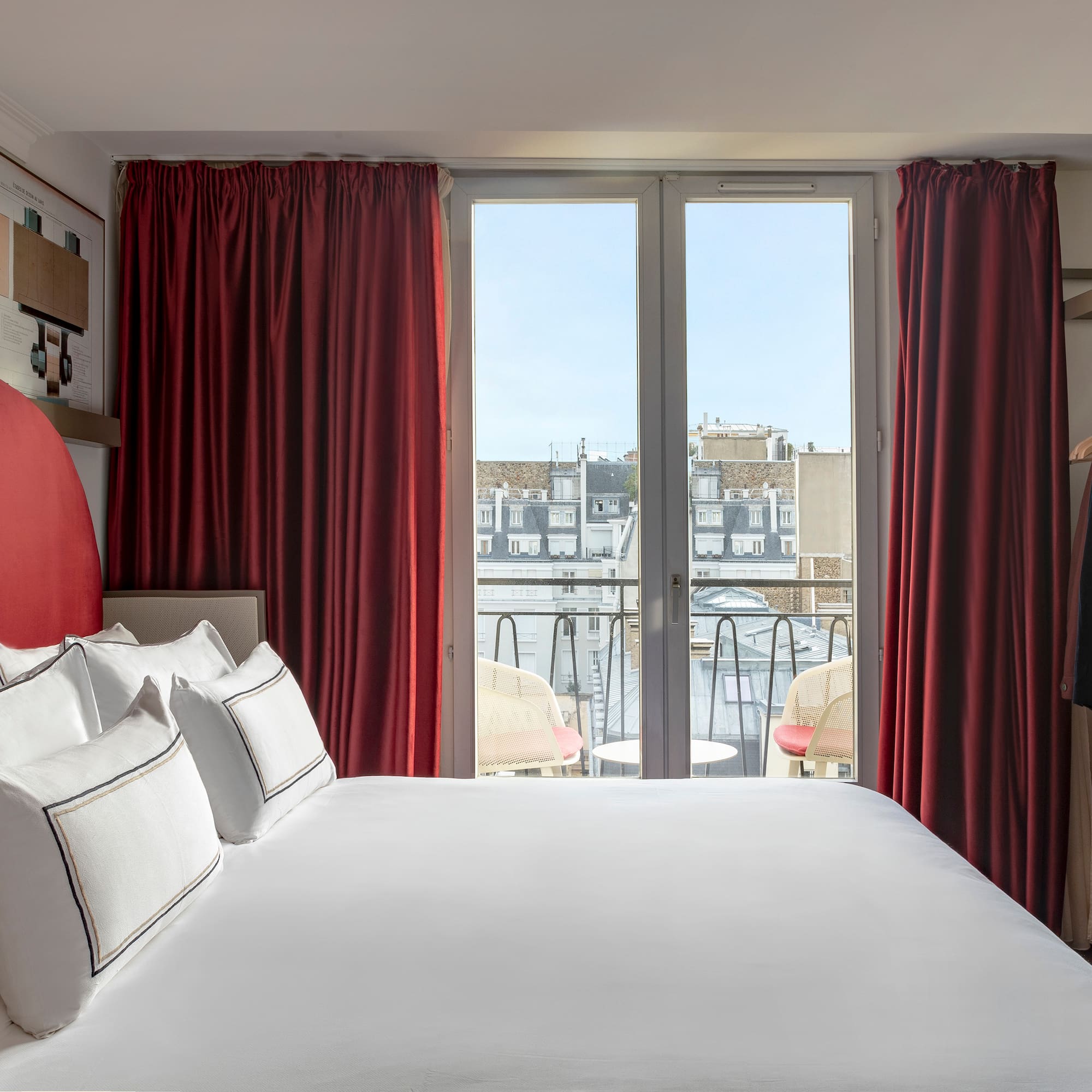 a bed with red curtains and a swinger with a window