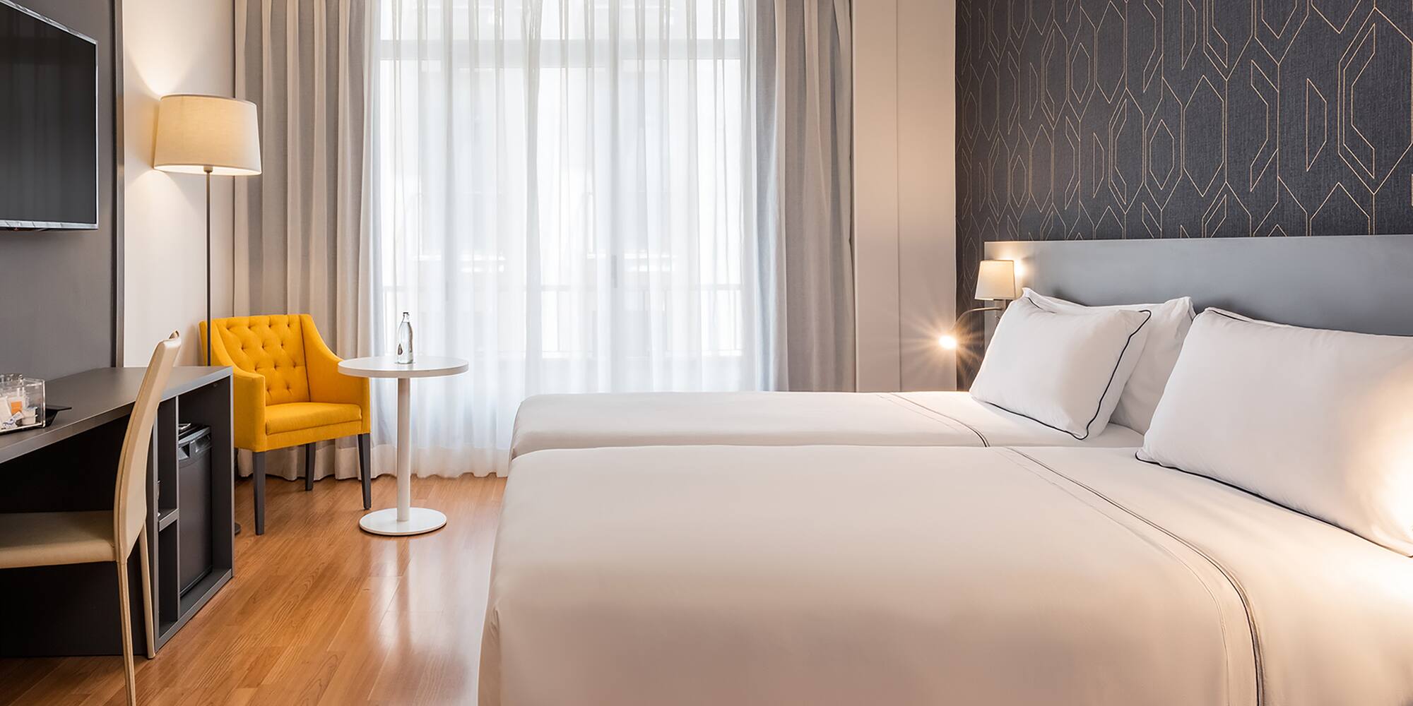 a room with two beds and a tv