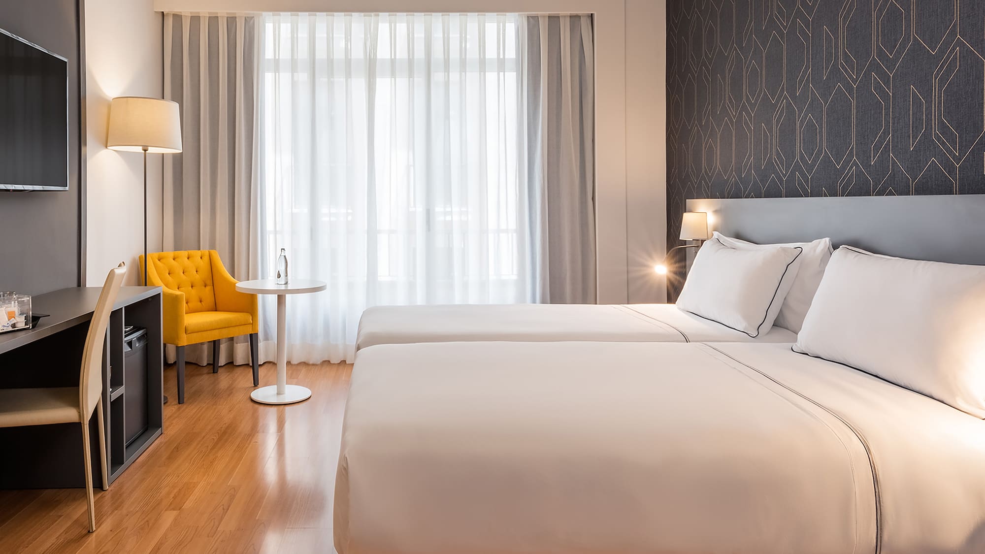 a room with two beds and a tv