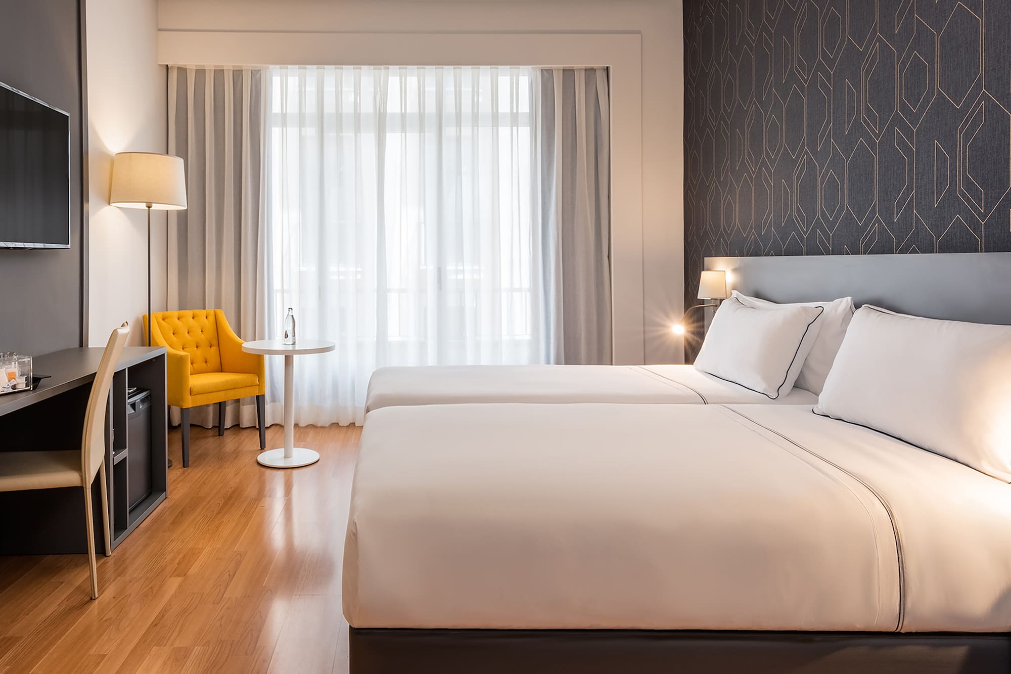 a room with two beds and a tv