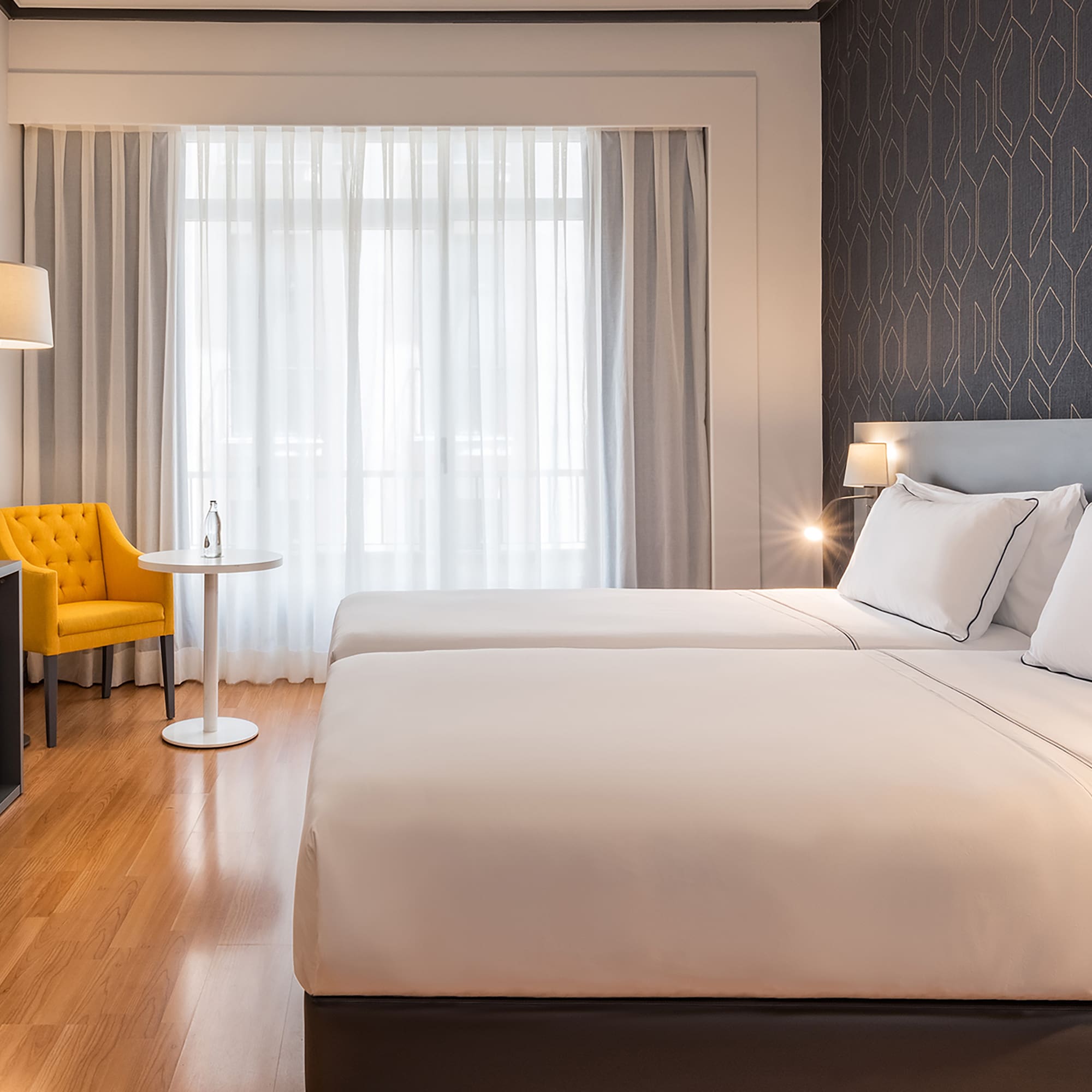 a room with two beds and a tv