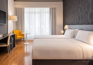 a room with two beds and a tv