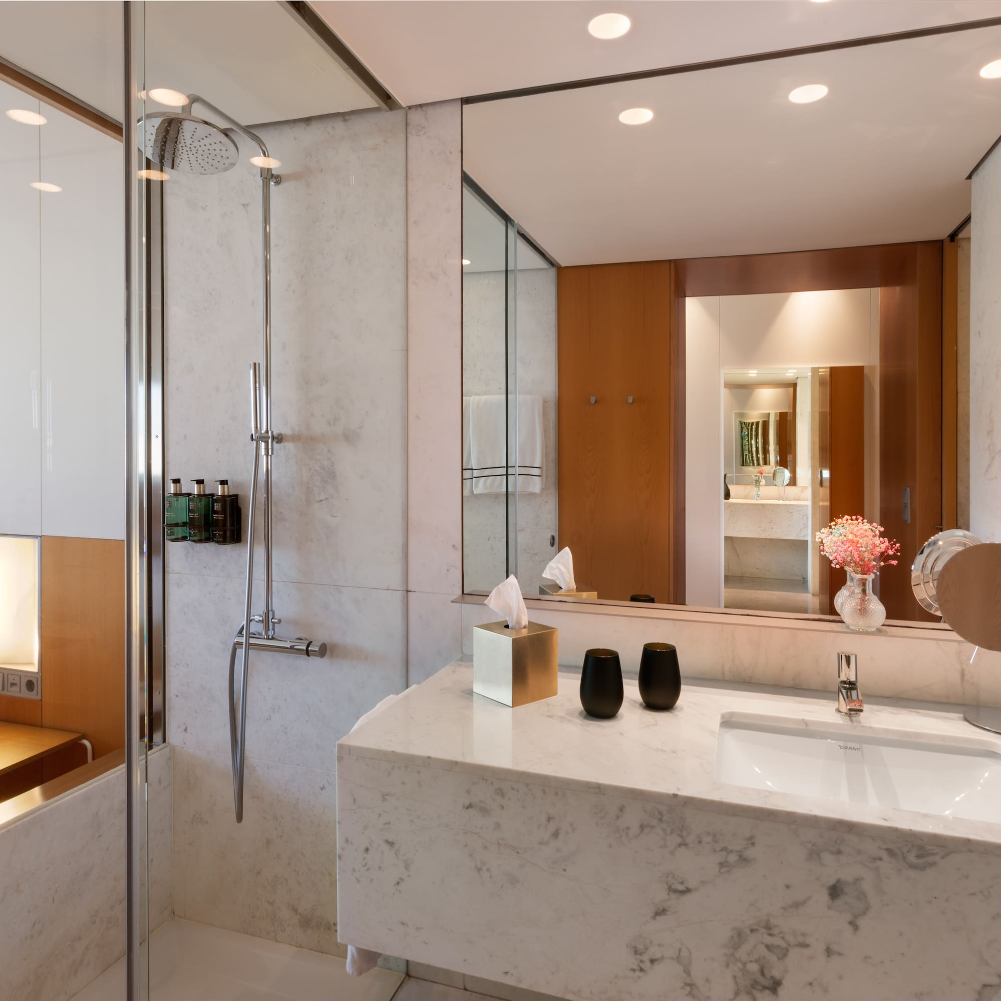 a bathroom with a marble countertop and shower