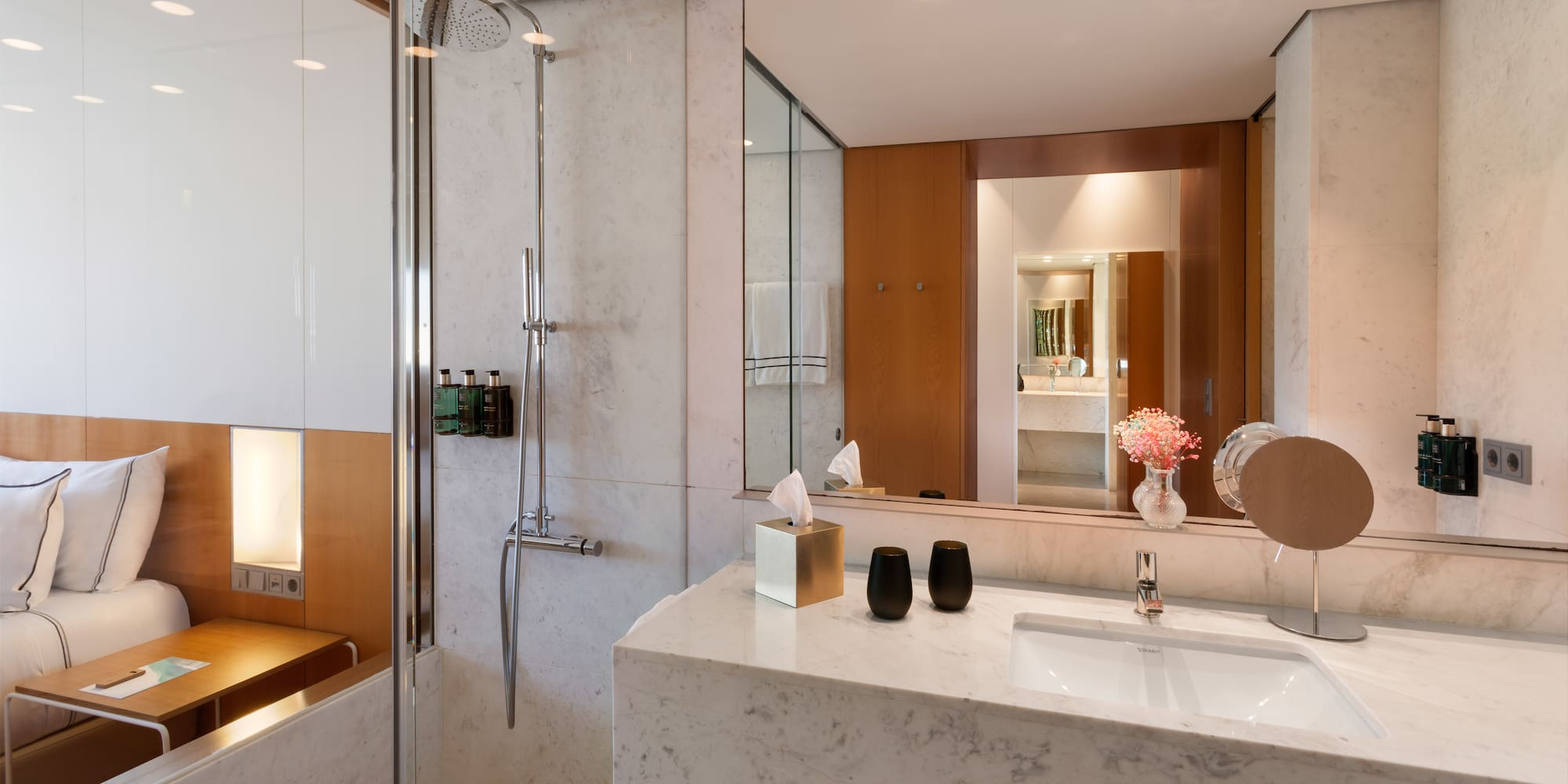a bathroom with a marble countertop and shower