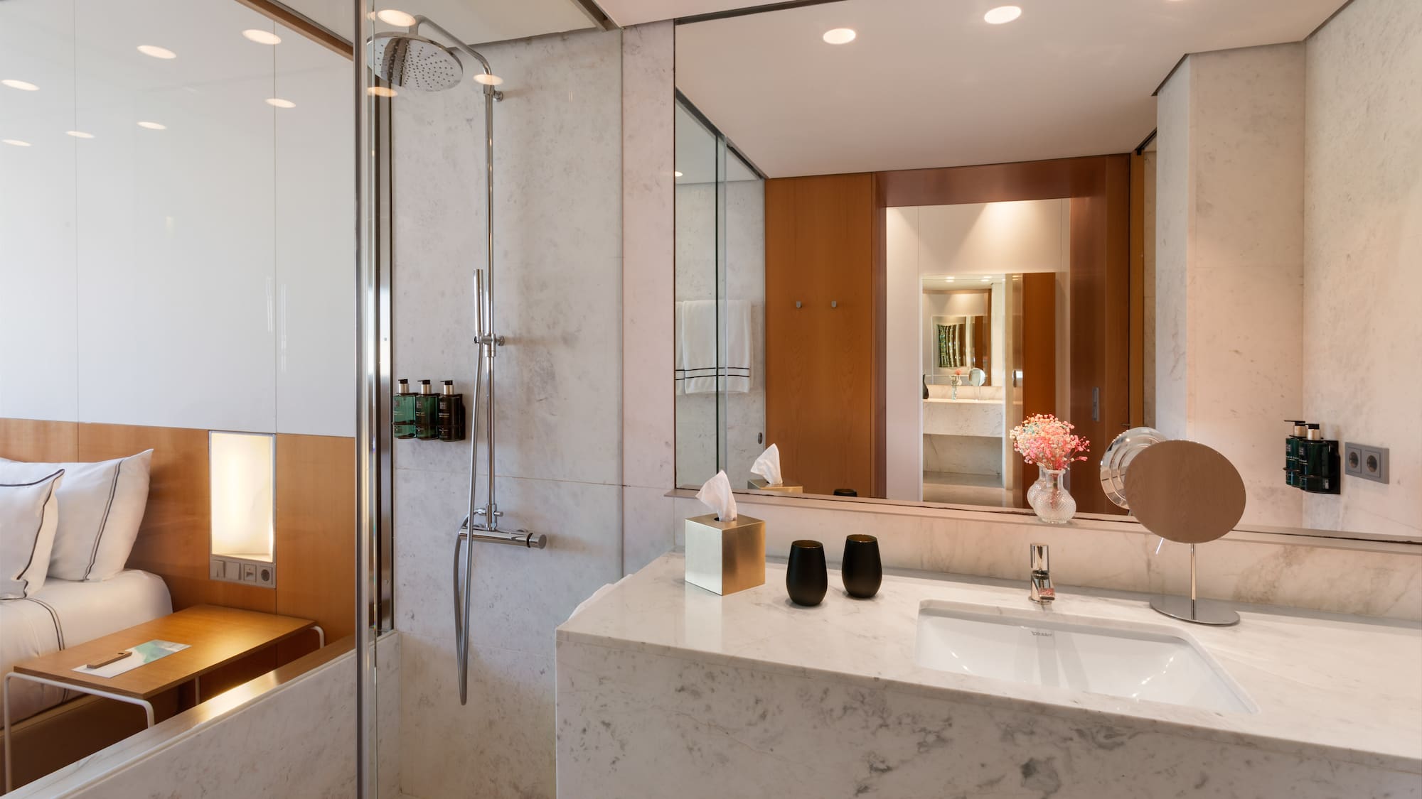 a bathroom with a marble countertop and shower