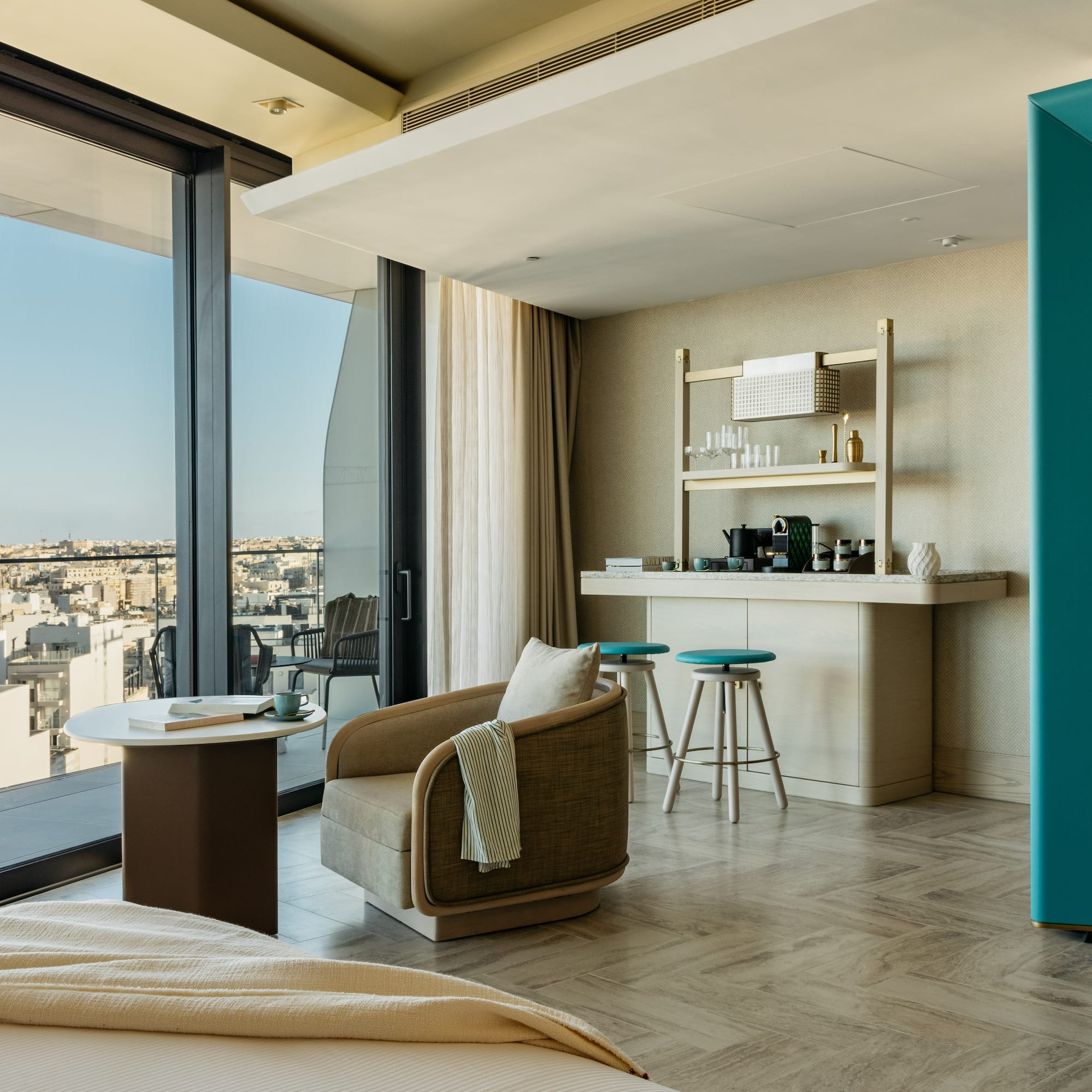 a room with a bed and a table and chairs