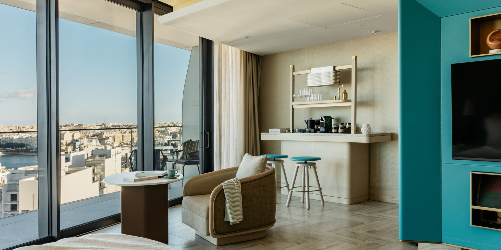 a room with a bed and a table and chairs