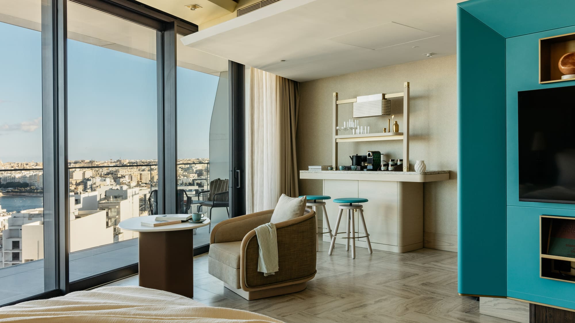 a room with a bed and a table and chairs