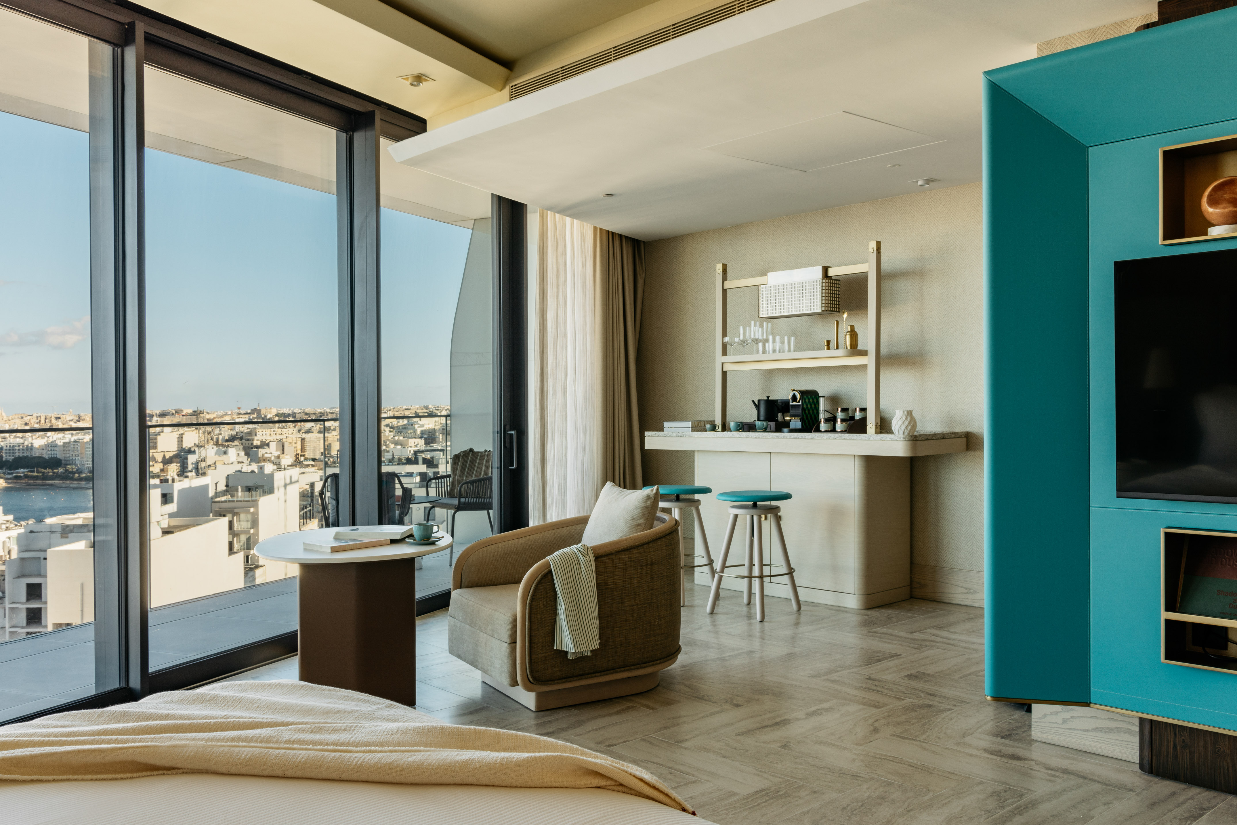 a room with a bed and a table and chairs