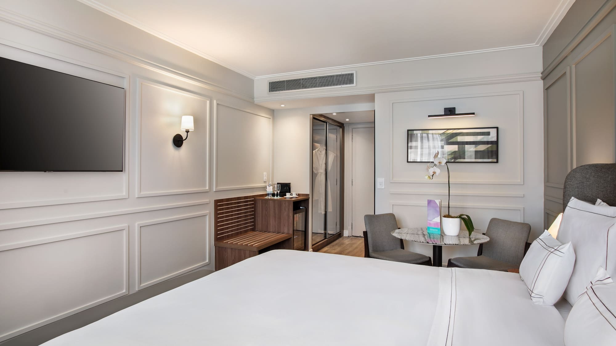 a room with a bed and chairs