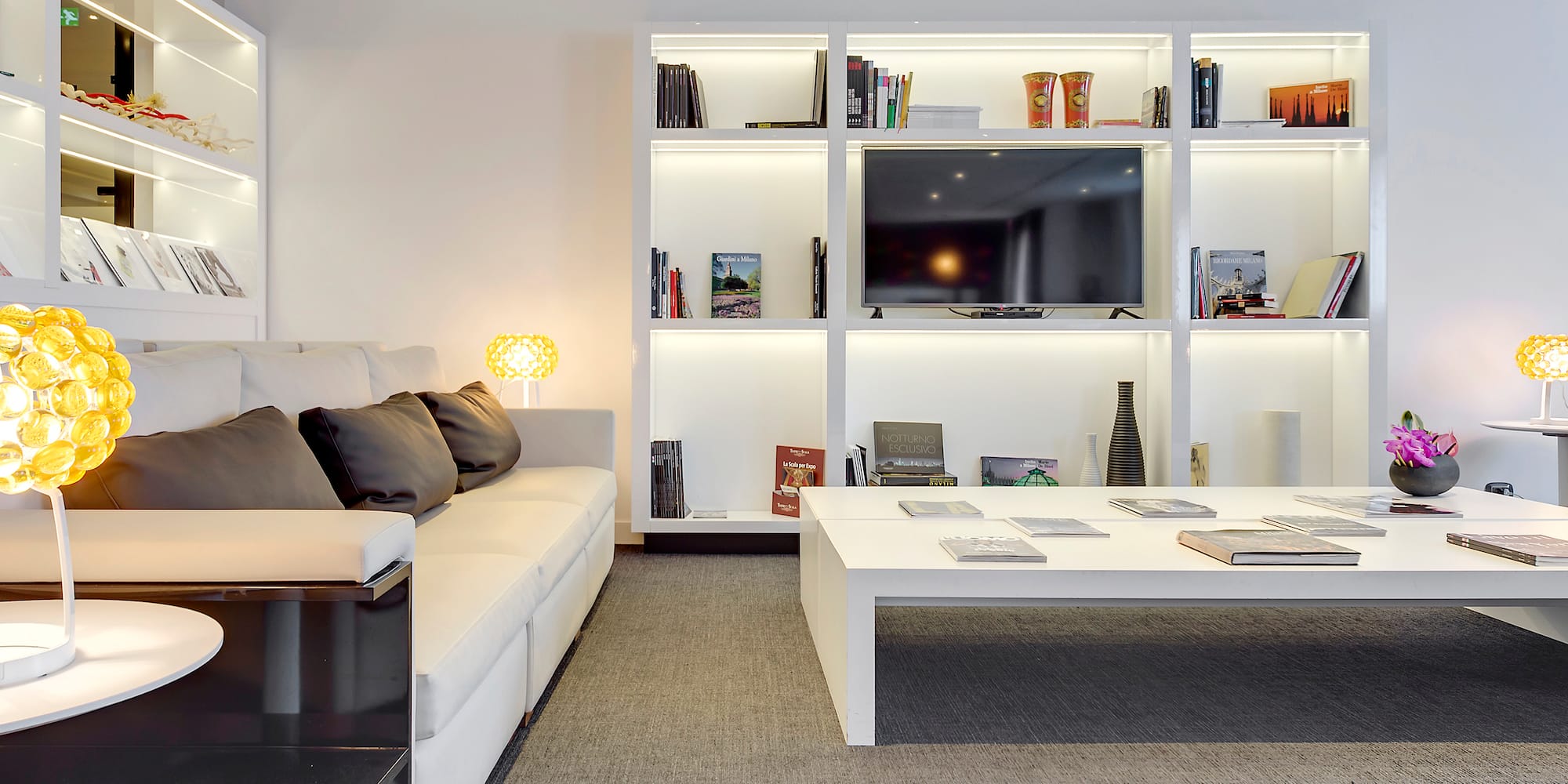 a living room with a white couch and a white coffee table
