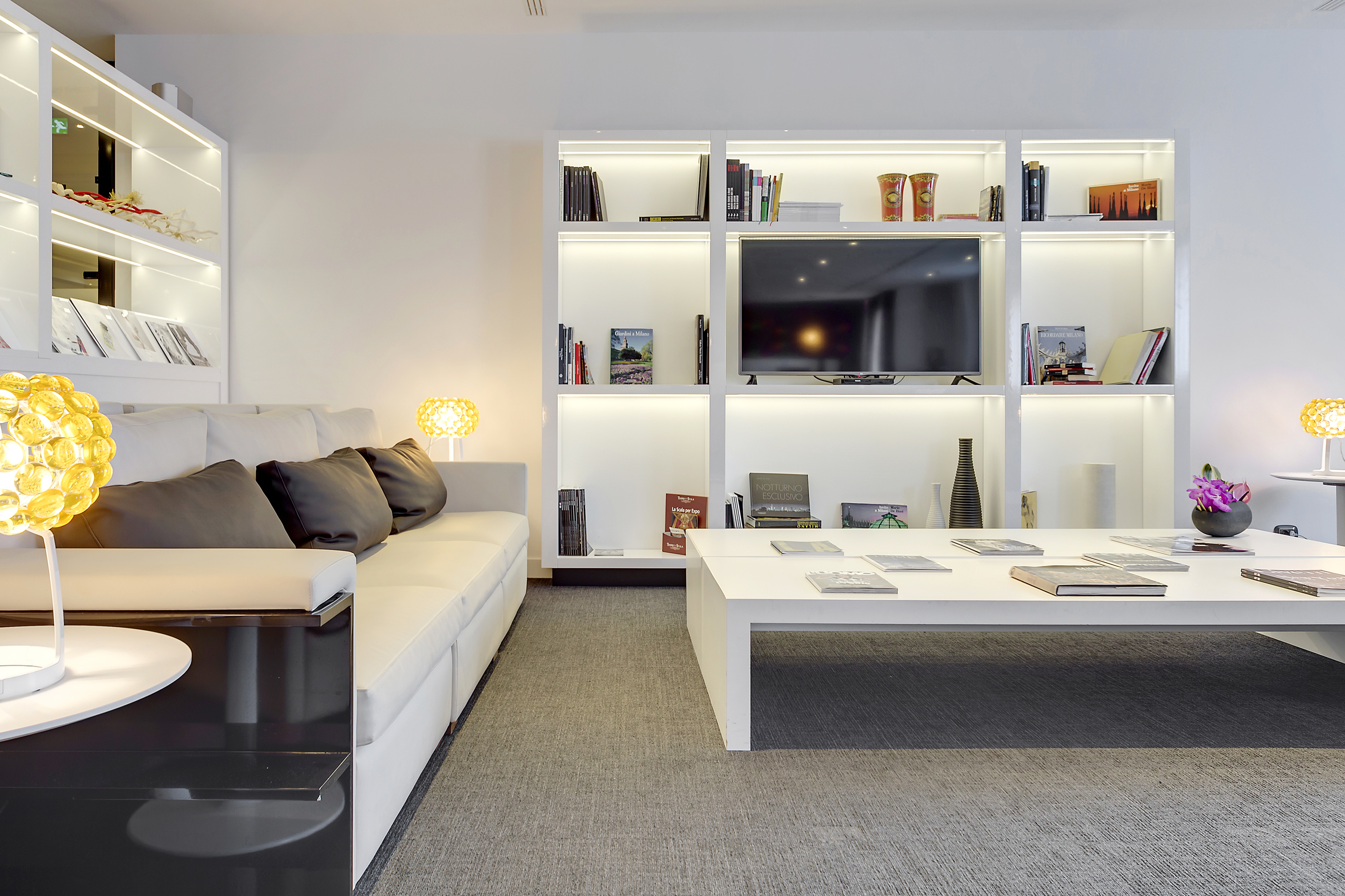 a living room with a white couch and a white coffee table