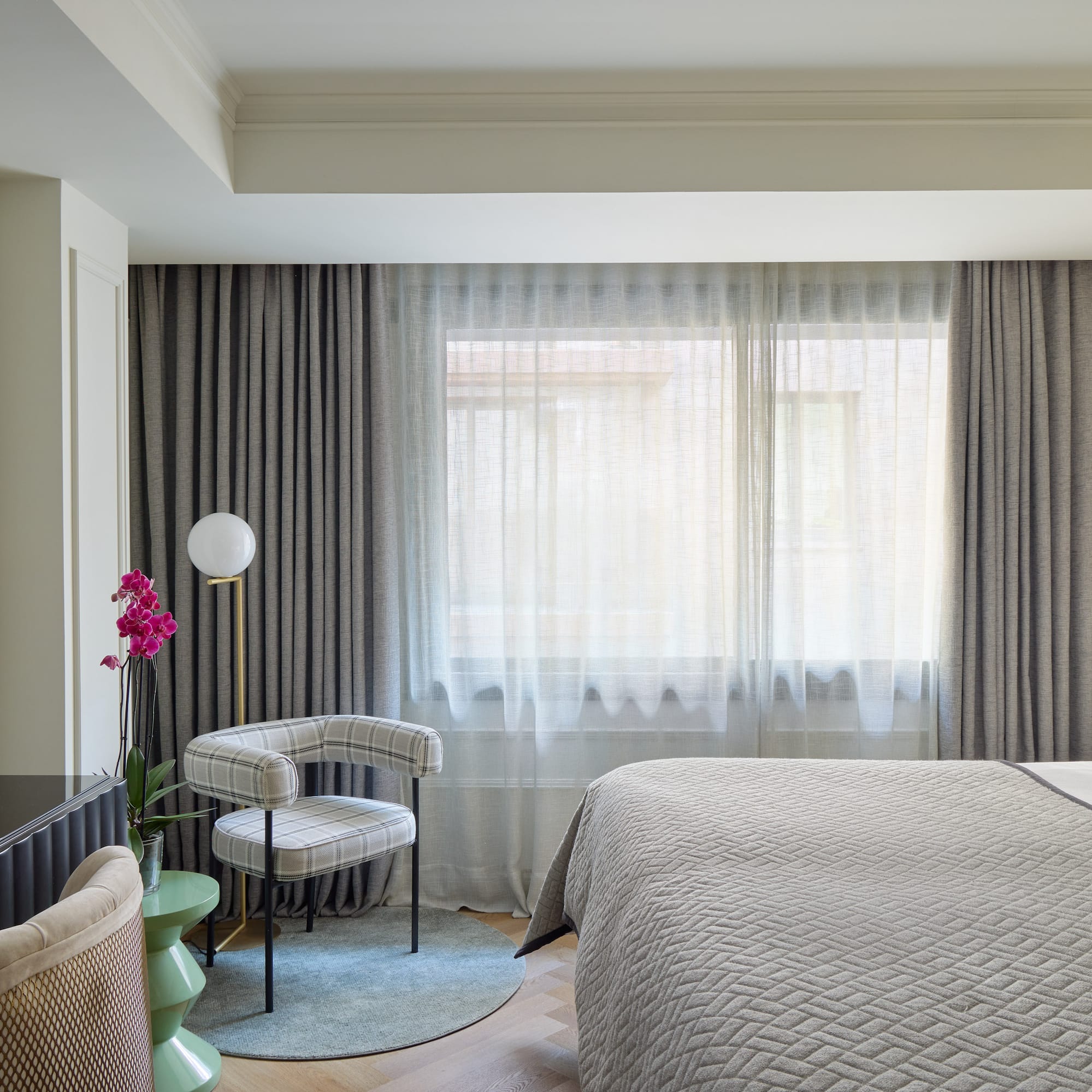 a bedroom with a bed and a chair