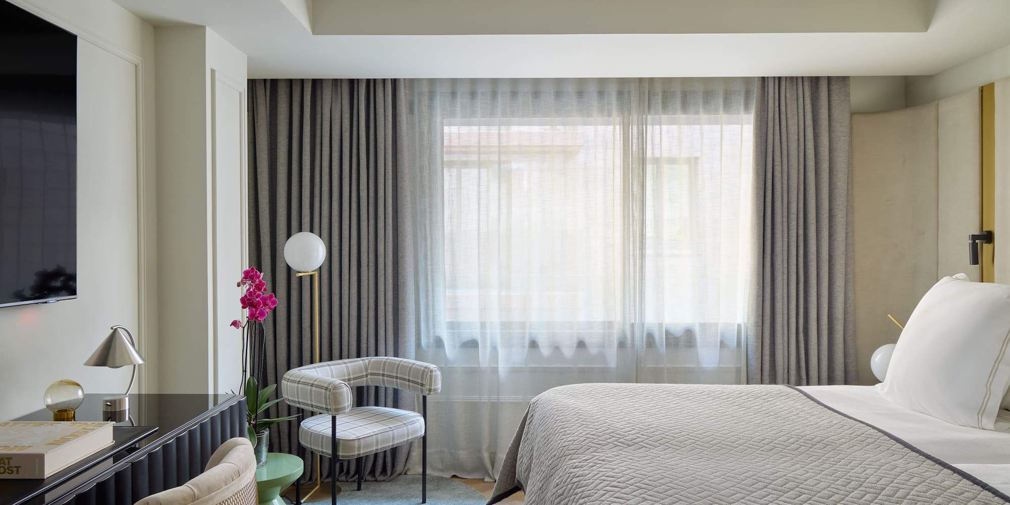 a bedroom with a bed and a chair